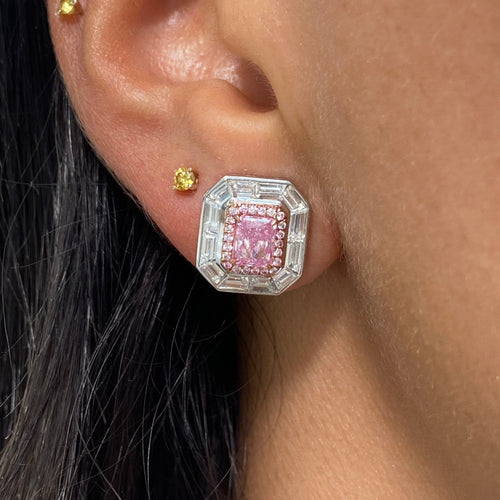 Natural pink elongated radiant diamond studs with GIA certified pink center and white diamond accents.