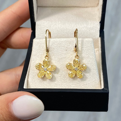 Unique flower shaped yellow diamond drop earrings with light yellow pear diamonds and round diamond center.