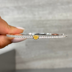 Unique heart shaped yellow diamond bangle with elongated white round diamonds and SI-VS1 clarity.