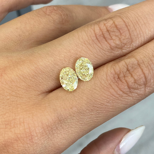 GIA certified matched pair of 2 natural yellow oval diamonds.