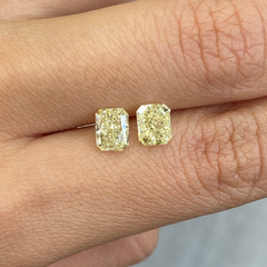 Matched pair of elongated natural yellow diamonds.