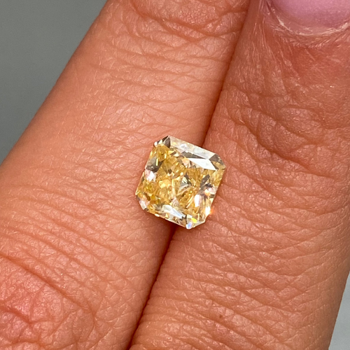 Vivid orange yellow radiant diamond with GIA certification and exceptional VVS1 clarity.