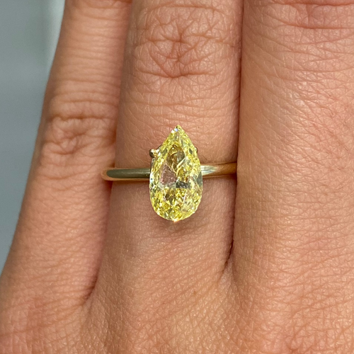 GIA certified fancy Intense Yellow pear-shaped diamond with SI1 clarity and vibrant brilliance.