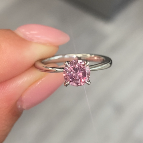 GIA certified Fancy Intense Pink round diamond engagement ring with pear shaped accents.