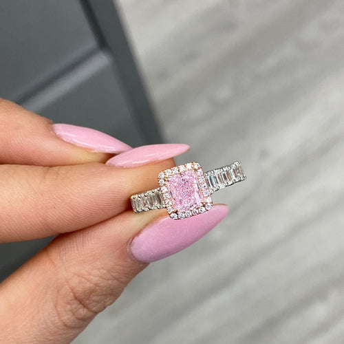 bubblegum pink diamond, pink radiant cut diamond surrounded by emerald cut and round diamonds, halo engagement ring with natural pink diamond