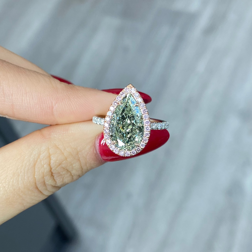 GIA certified fancy pear shaped green ring with pink diamonds. 