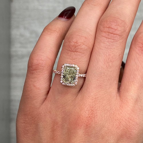 Fancy greenish-yellow radiant cut diamond halo ring with pink diamonds and VS2 clarity.