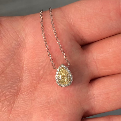 Simple yet elegant yellow diamond pedant that would compliment anyones collection. 1 Carat carat natural fancy light yellow pear shape diamond. Set in 18 karat gold with classic halo. Handmade in New York City.