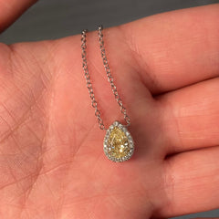 Simple yet elegant yellow diamond pedant that would compliment anyones collection. 1 Carat carat natural fancy light yellow pear shape diamond. Set in 18 karat gold with classic halo. Handmade in New York City.