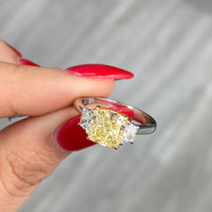 2.28 Carat Center Fancy Light Yellow Cushion Cut Diamond  SI2 Clarity 0.32 Carats of E Color Trapezoids GIA Certified Diamond  Crafted in Platinum and 18k Yellow Gold Handmade in NYC