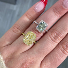 Fancy greenish-yellow radiant cut diamond halo ring with pink diamonds and VS2 clarity.