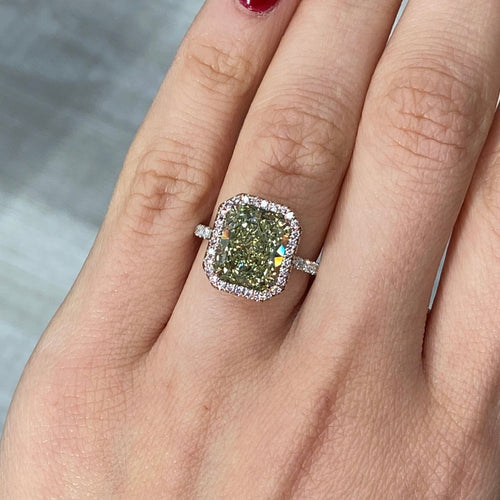 Elegant radiant cut engagement ring featuring a fancy greenish yellow elongated diamond with SI2 clarity.