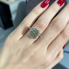 Elegant radiant cut engagement ring featuring a fancy greenish yellow elongated diamond with SI2 clarity.