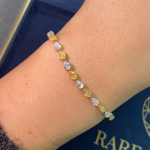 Luxurious bracelet pear-shaped fancy yellow and white diamonds in an elegant design.