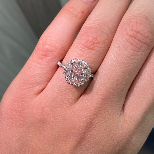 1.5 carat elongated radiant cut diamond ring. natural pink diamond ring, fancy light orangy pink diamond, halo diamond ring with pink diamond.