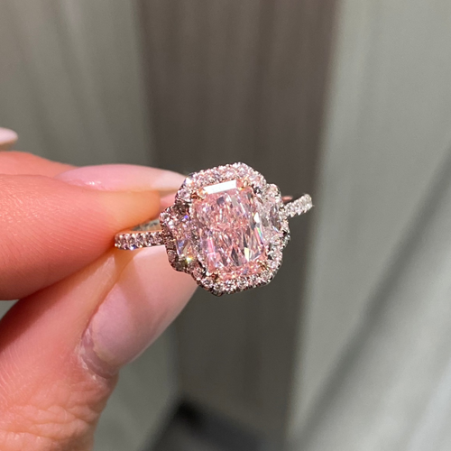 1.5 carat elongated radiant cut diamond ring. natural pink diamond ring, fancy light orangy pink diamond, halo diamond ring with pink diamond.