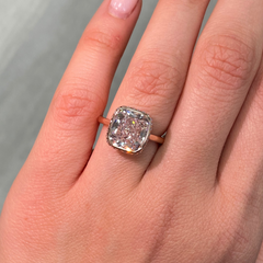 Elegant bezel set ring featuring a GIA certified very light pink cushion cut diamond.