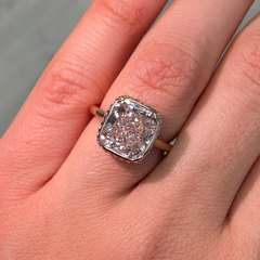 Elegant bezel set ring featuring a GIA certified very light pink cushion cut diamond.