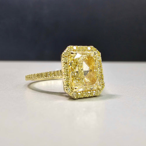 2.28 Carat Center Diamond GIA Light Yellow Diamond (Y-Z) Radiant Cut Diamond 0.30 Carats of Fancy Yellow Rounds VS1 Clarity Medium Blue Fluorescence Excellent, Very Good cutting Set in 18k Yellow Gold GIA Certified Diamond Handmade in NYC