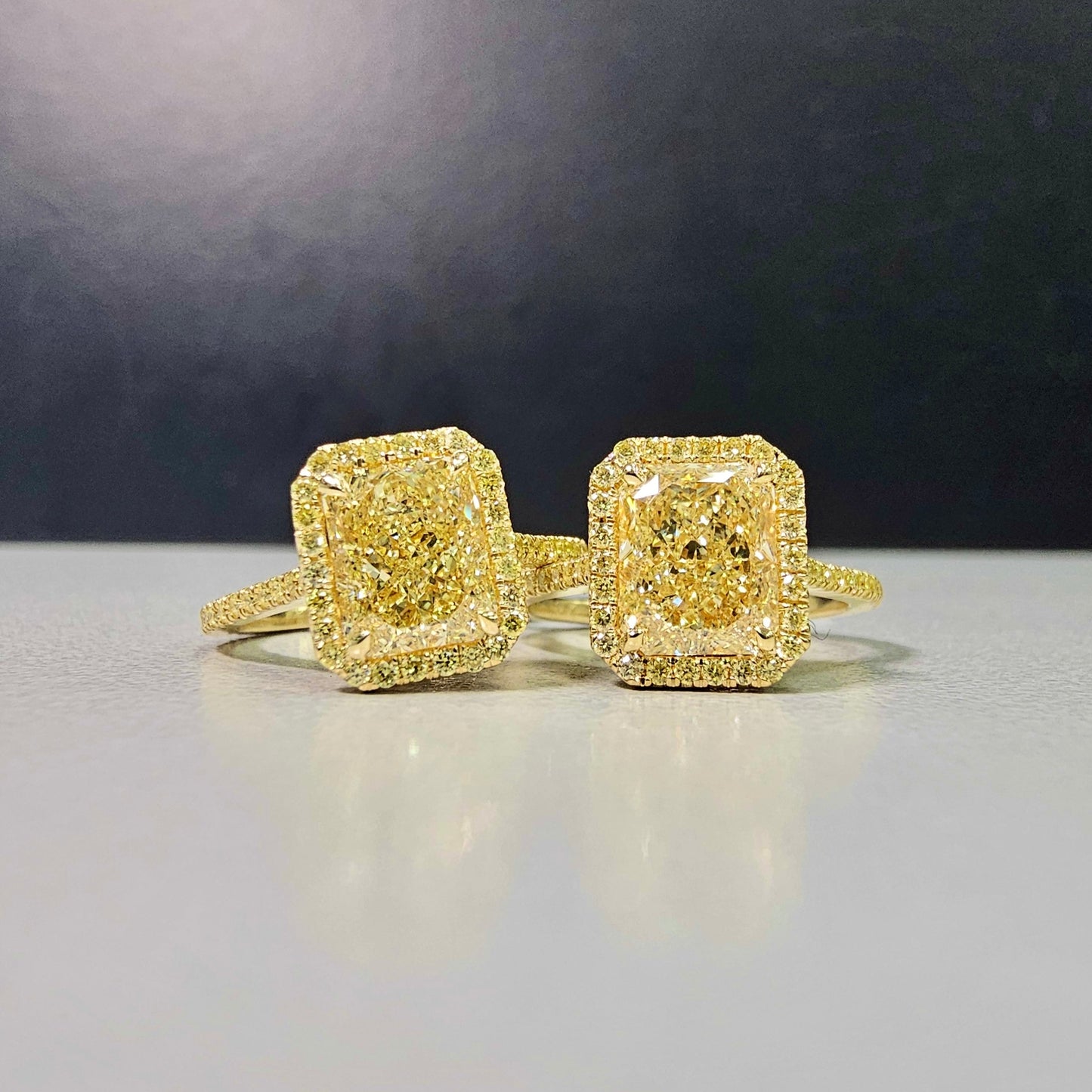 2.28 Carat Center Diamond GIA Light Yellow Diamond (Y-Z) Radiant Cut Diamond  0.30 Carats of Fancy Yellow Rounds  VS1 Clarity  Medium Blue Fluorescence Excellent, Very Good cutting Set in 18k Yellow Gold  GIA Certified Diamond Handmade in NYC 
