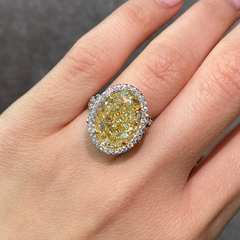 Yellow Oval Diamond Halo Ring with a handcrafted setting and GIA certified side diamonds.