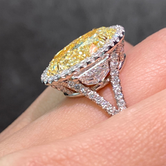 Yellow Oval Diamond Halo Ring with a handcrafted setting and GIA certified side diamonds.