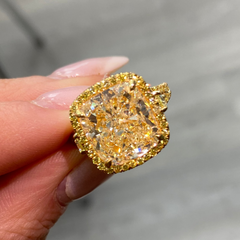 Unique light yellow cushion diamond ring with yellow diamond halo setting.