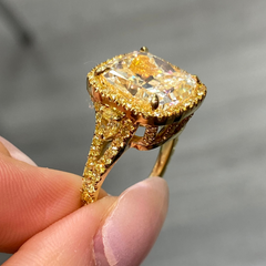 Unique light yellow cushion diamond ring with yellow diamond halo setting.