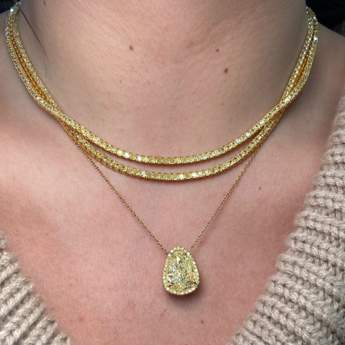 Luxurious tennis necklace featuring natural yellow cushion cut diamonds with VS-VVS clarity.