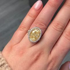 Yellow Oval Diamond Halo Ring with a handcrafted setting and GIA certified side diamonds.