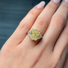 Elegant fancy light yellow elongated radiant diamond ring with VS2 clarity, unique and striking design.