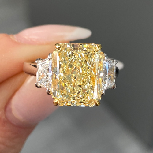 Elegant fancy light yellow elongated radiant diamond ring with VS2 clarity, unique and striking design.