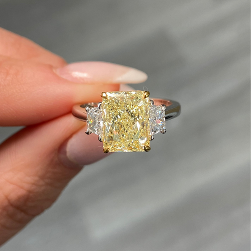 Fancy light yellow elongated radiant cut diamond engagement ring with VVS2 clarity.