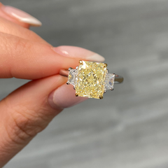 Fancy light yellow elongated radiant cut diamond engagement ring with VVS2 clarity.