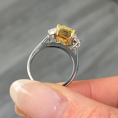 Fancy light yellow elongated radiant cut diamond engagement ring with VVS1 clarity.