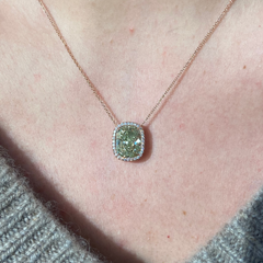 Elegant green cushion cut diamond pendant with a pink halo, featuring GIA-certified diamonds.