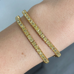 Elegant fancy yellow cushion cut diamond tennis bracelet featuring VS-VVS clarity.