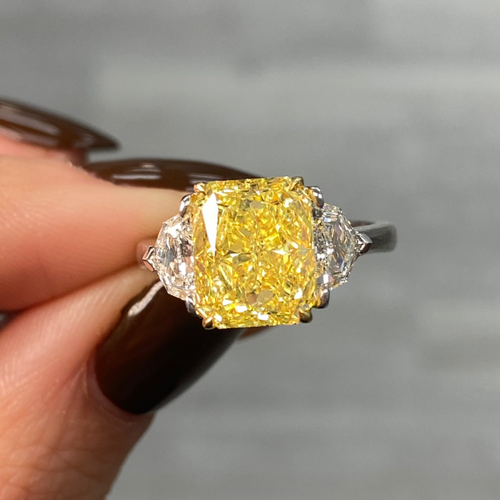 GIA certified fancy vivid yellow elongated radiant diamond engagement ring, internally flawless and stunning.