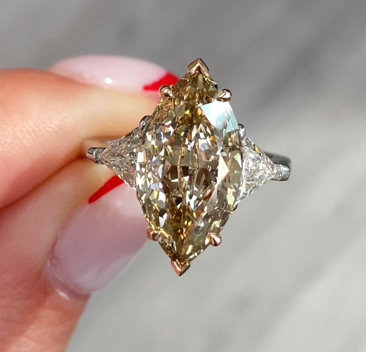 natural champagne diamond marquise cut engagement ring, unique engagement ring with trillion side stones.