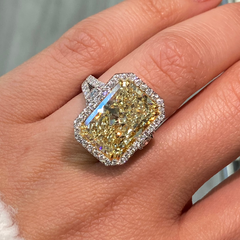 GIA certified elongated radiant yellow diamond halo ring, featuring a soft and sweet yellow hue.