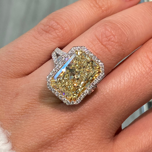 GIA certified elongated radiant yellow diamond halo ring, featuring a soft and sweet yellow hue.