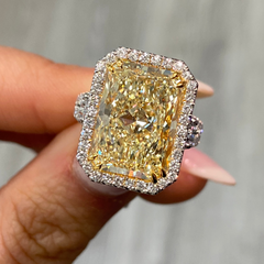 GIA certified elongated radiant yellow diamond halo ring, featuring a soft and sweet yellow hue.