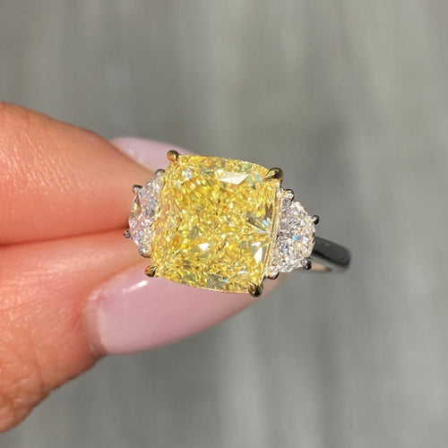 GIA certified Fancy Yellow Cushion Diamond Engagement Ring with VS2 clarity and excellent cutting.