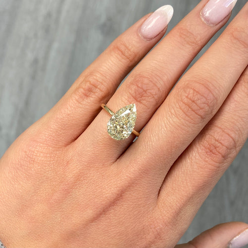 Light yellow pear-shaped diamond with VS1 clarity, excellent cut, and GIA certified.