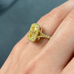 GIA certified light yellow elongated cushion cut diamond ring with canary yellow and golden yellow diamonds, SI1 clarity.