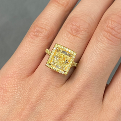 GIA certified light yellow elongated cushion cut halo diamond engagement ring with canary yellow, SI1 clarity.