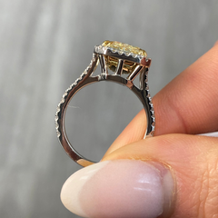 Light yellow radiant cut diamond engagement ring with a white diamond halo, VS2 clarity.