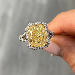 Light yellow radiant cut diamond engagement ring with a white diamond halo, VS2 clarity.