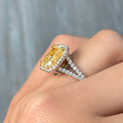 Light yellow radiant cut diamond engagement ring with a white diamond halo, VS2 clarity.