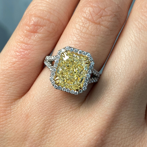 Light yellow radiant cut diamond engagement ring with a white diamond halo, VS2 clarity.